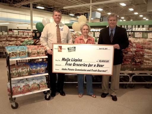 Maija Liepins (center) was awarded a giant-sized check that represents free groceries for a year at her favorite store, Meijer. Presenting the check are Ed Cunningham, Supermarket Manager, Meijer (left) and Jim McMath, Regional Sales Manager, Fresh Gourmet Company (right).