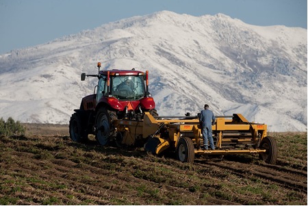 A farmer harvests his field in Tetonia, Idaho. (Photo Courtesy of David Stoecklein)