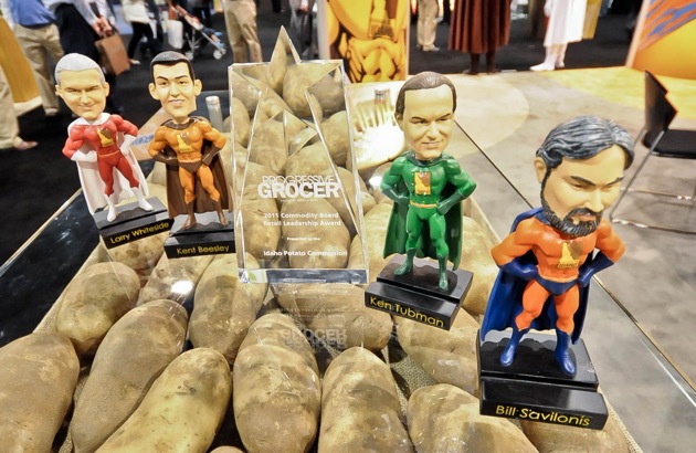 Progressive Grocer's Commodity Board Retail Leadership Award surrounded by the Fearless Field Force bobbleheads.